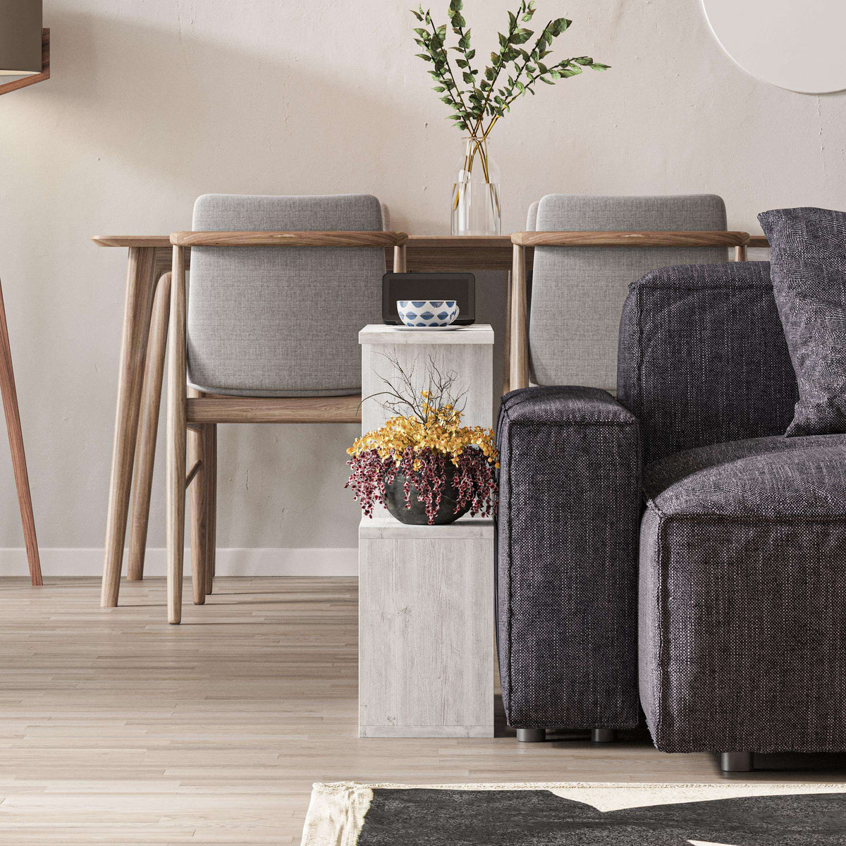 Side table with four open shelves in light gray wood, showing top and storage cubbies