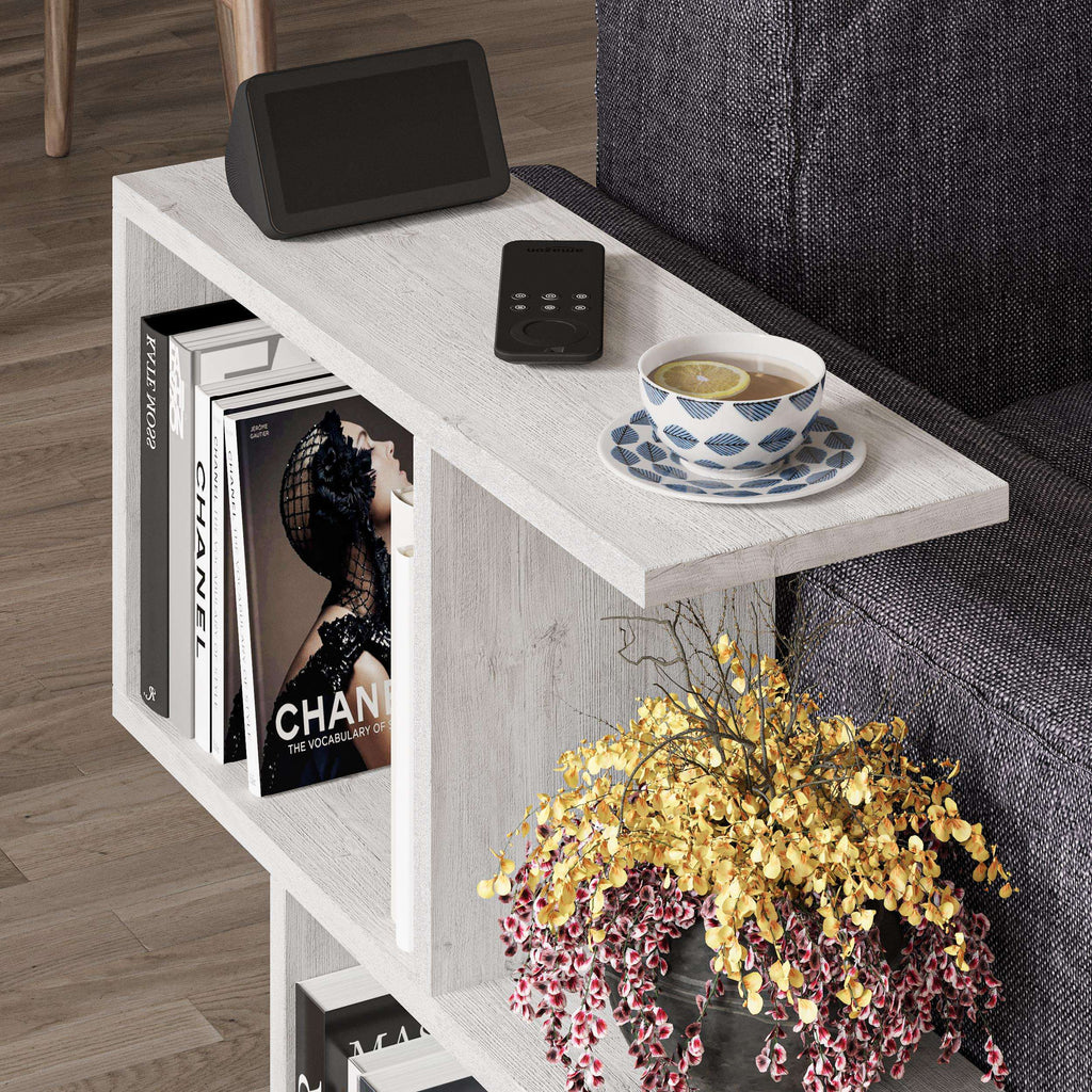 Side table with four open shelves in light wood, featuring wide top and book storage