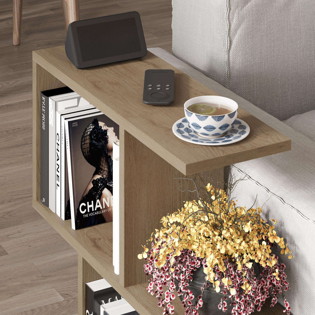 Modern side table with 4 open shelves, light wood top and gray shelves with books