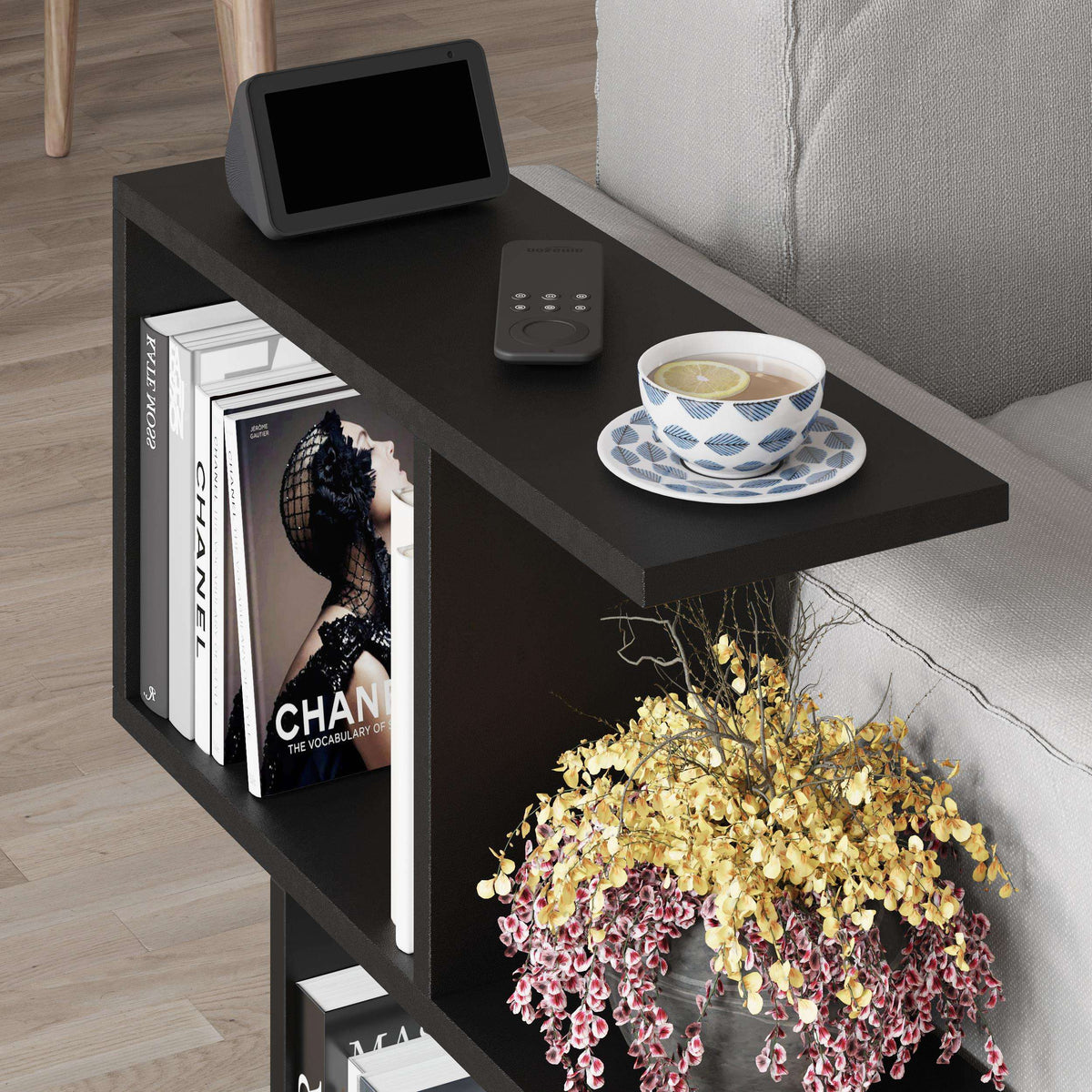 Modern side table with four open shelves, dark wood, tablet and cup on top