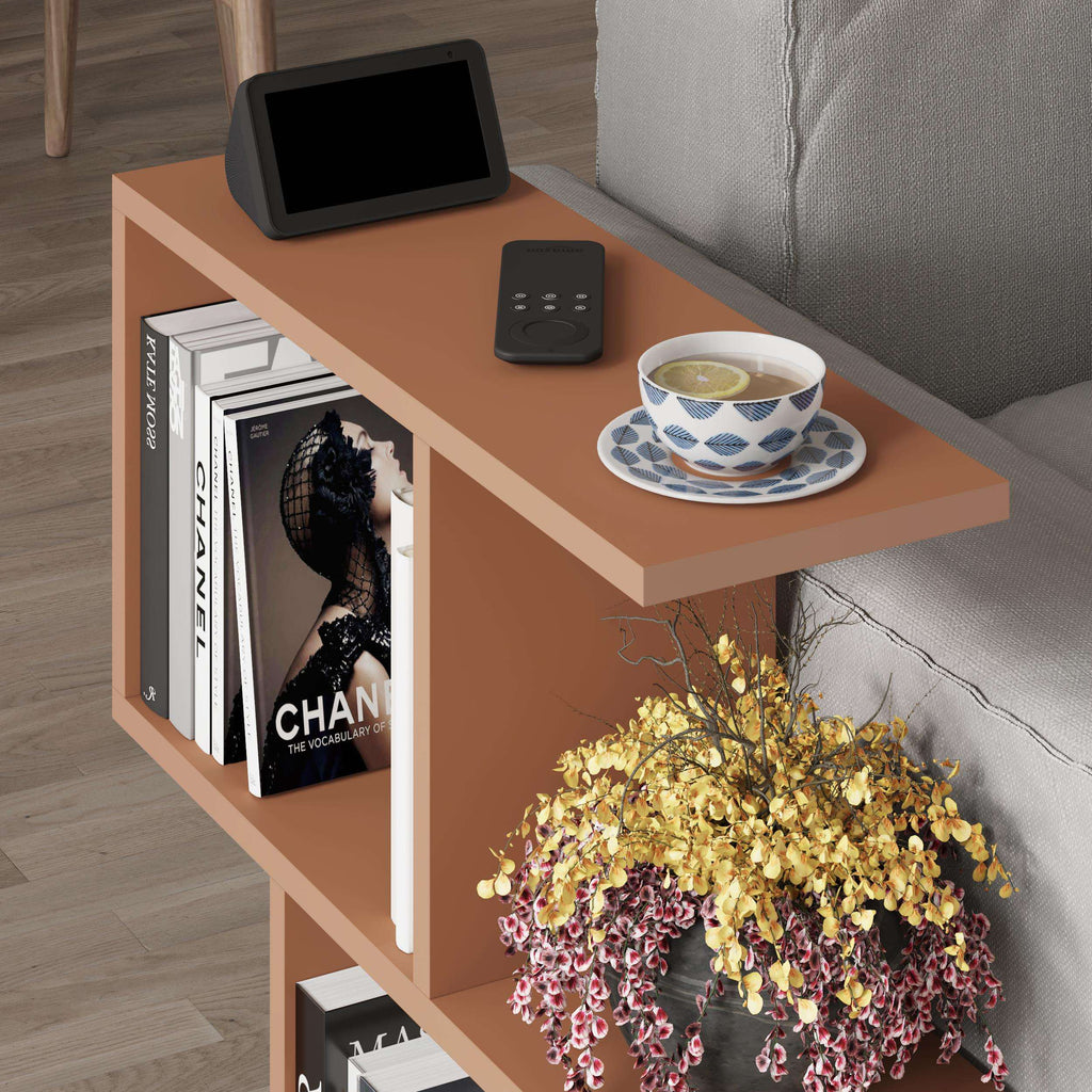 Modern side table with 4 open shelves, tan frame and top, side view with books