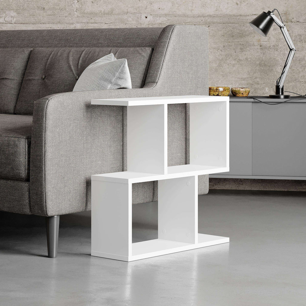 Modern side table with four open shelves in white, open cubbies beside a sofa