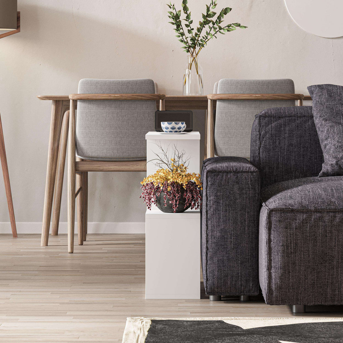 Modern side table with white frame and 4 open shelves, styled with decor on top