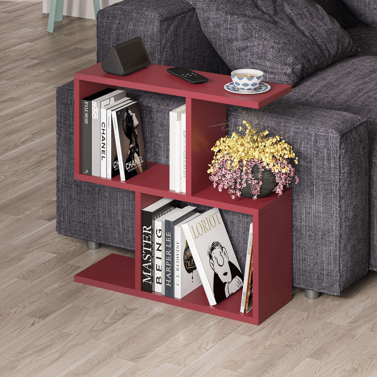 Red modern side table with four open shelves, flat top, and open book display