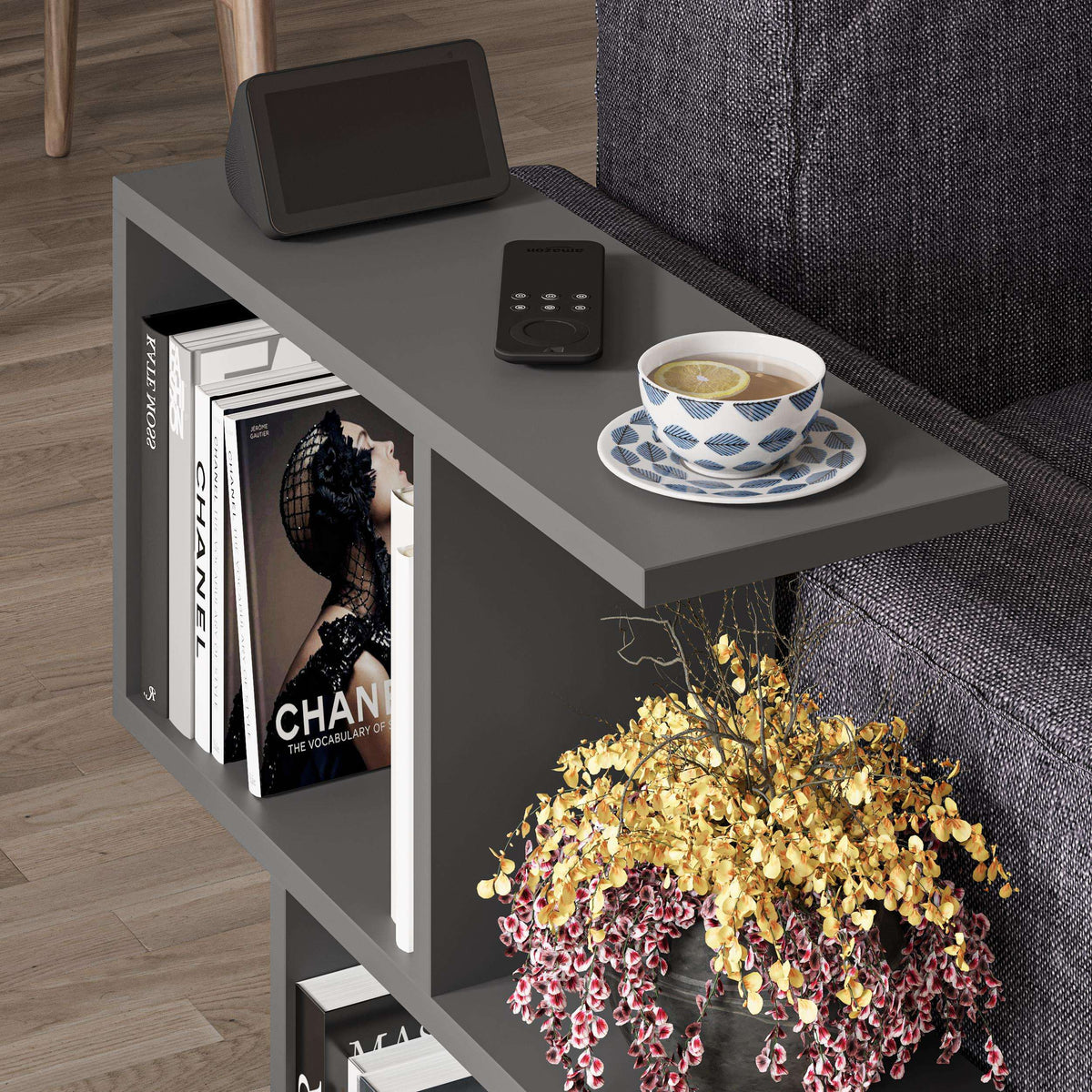 Modern side table with 4 open shelves, dark grey top and open cubby storage.