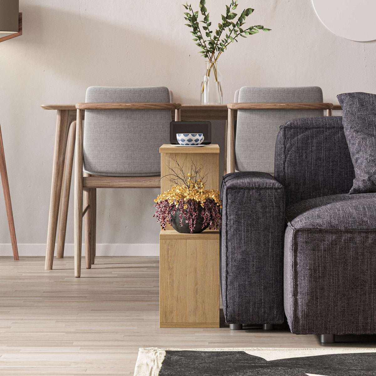 Modern side table with four open shelves in light wood, holding small vase and decor