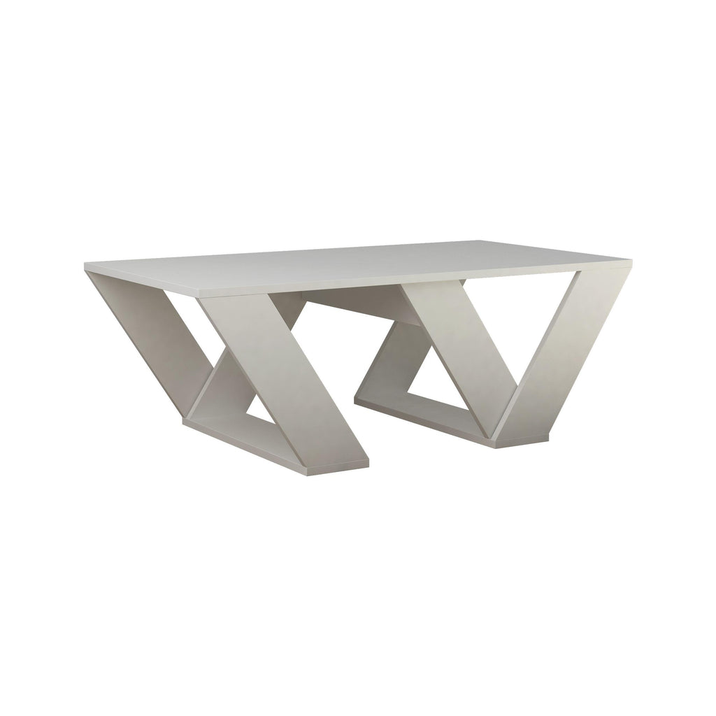 White geometric coffee table with open-frame cross legs and rectangular top