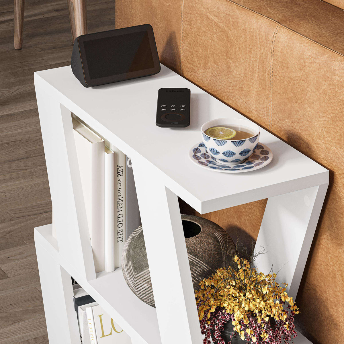 Compact modern side table with white frame, black top, and open shelf for books