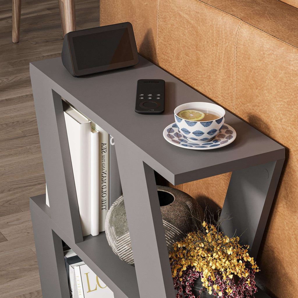 Compact modern side table with grey frame, open shelves, and a cup on the top