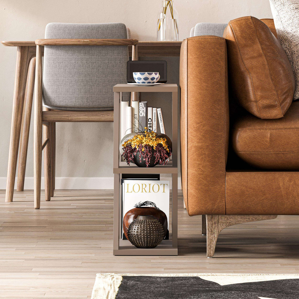 Compact modern side table with open shelves, white finish, beside brown leather sofa