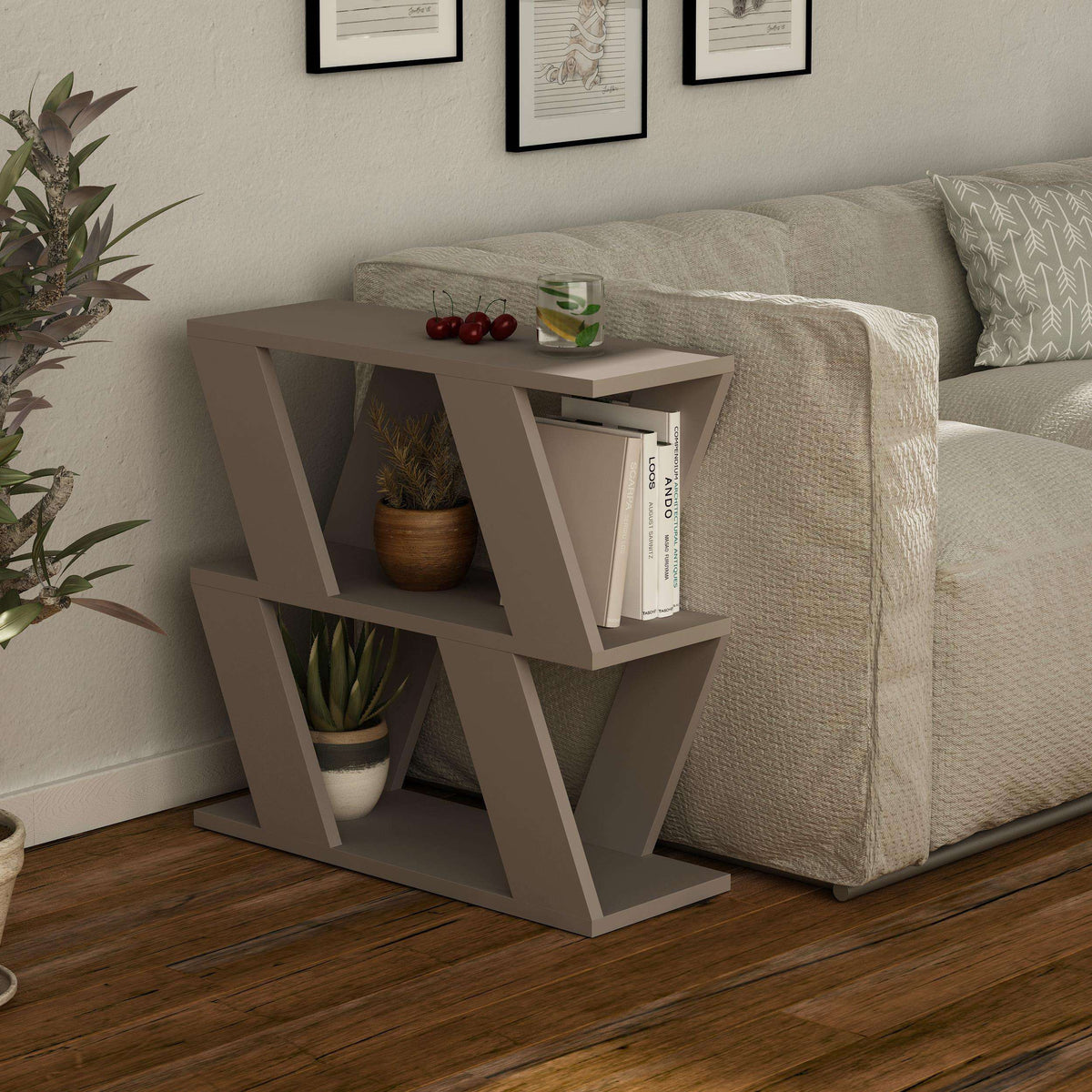 Compact modern side table with open shelves, white finish, next to gray upholstered sofa