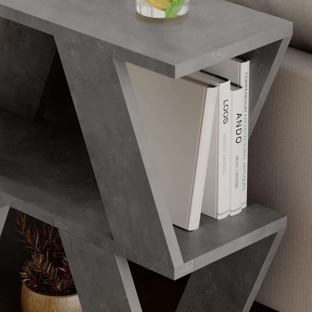 Open cubby shelves on compact side table with grey frame and books inside