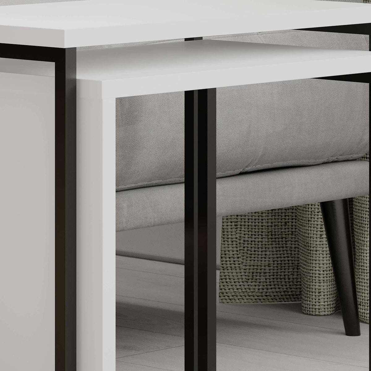 Close-up of white nesting side table with black metal frame and open shelf