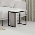 White nesting side table set with black metal frame and open lower shelf