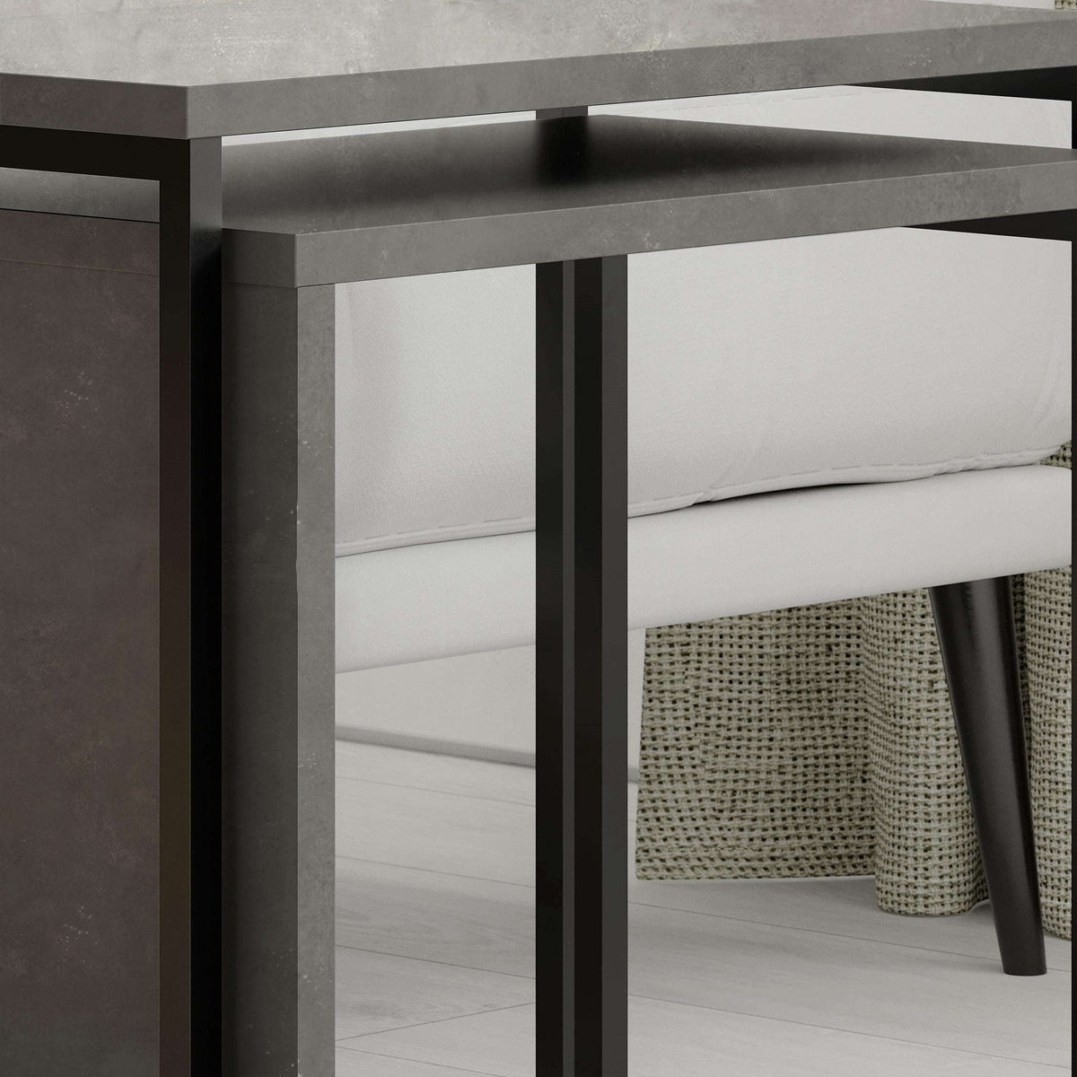 Dark grey nesting side table pair, metal frame with open lower shelf and side panel.