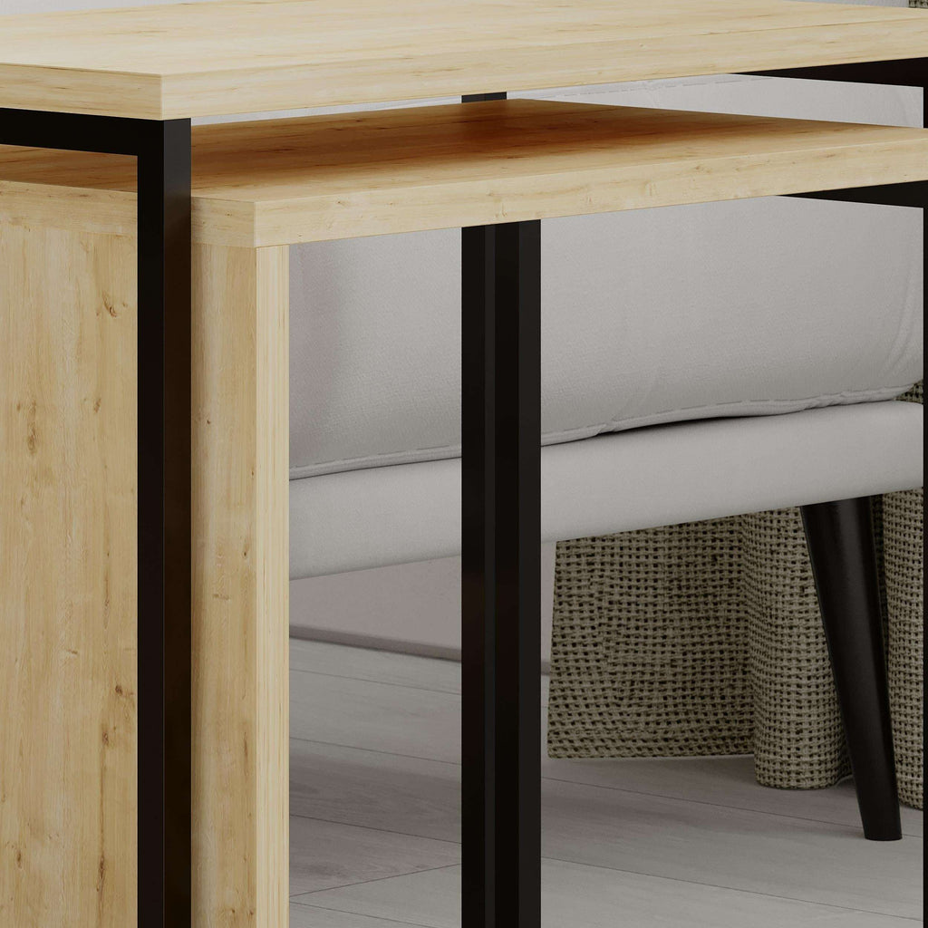Light oak nesting side table close-up with black metal legs and open lower shelf.