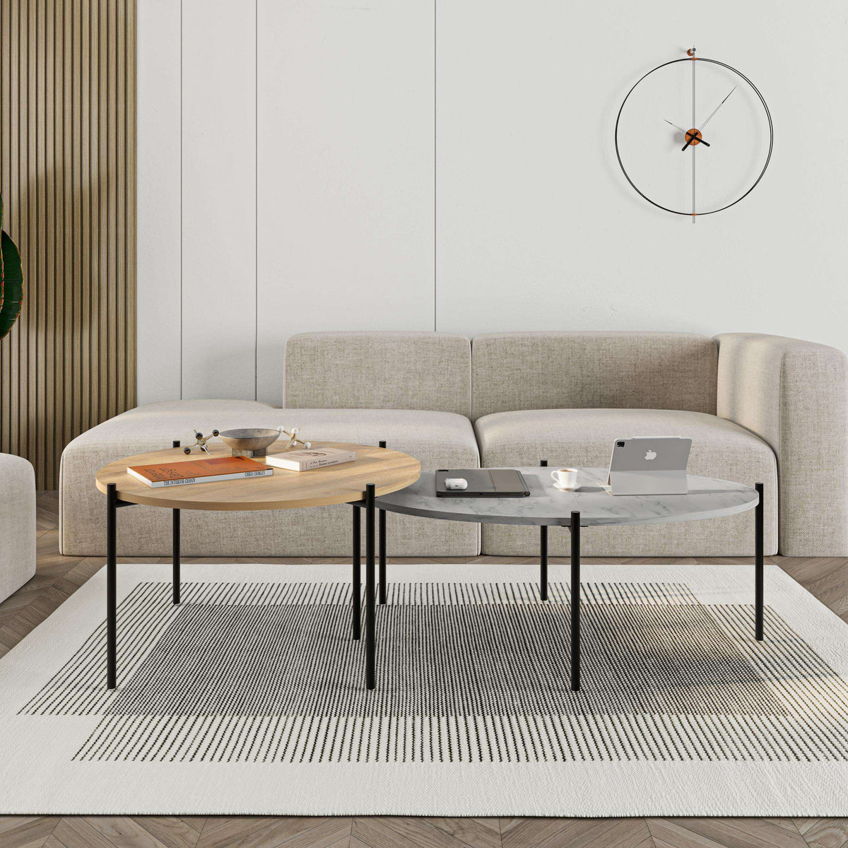 Coffee table set with two nested tables: light wood round top and dark oval top on legs.