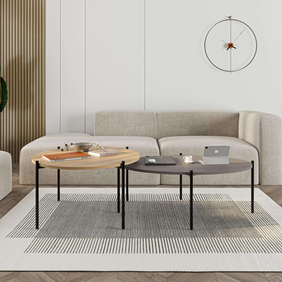 Round and oval coffee tables nested together, light wood and dark tops with black frames.
