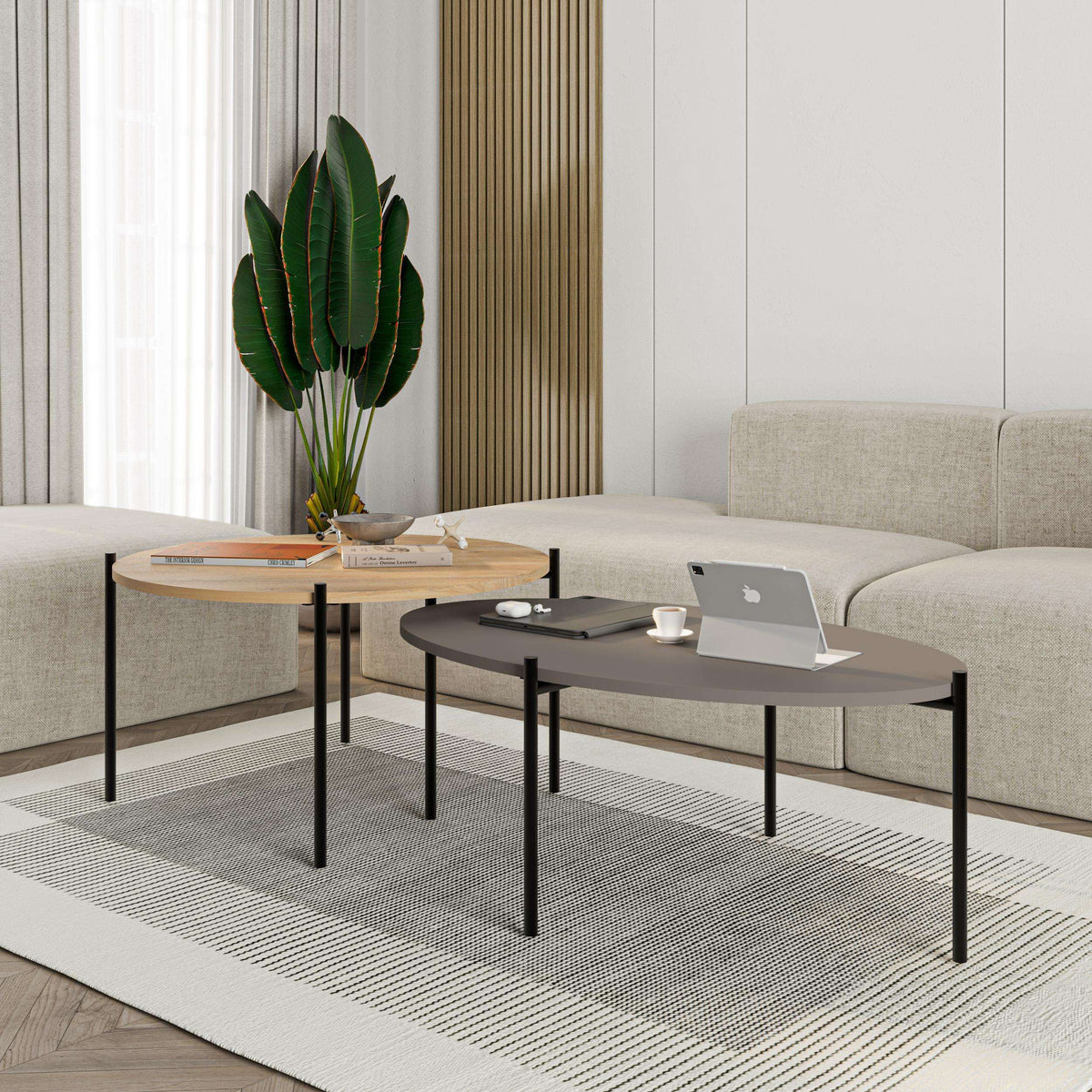 Round and oval coffee table set with light wood top, dark top, and black metal legs