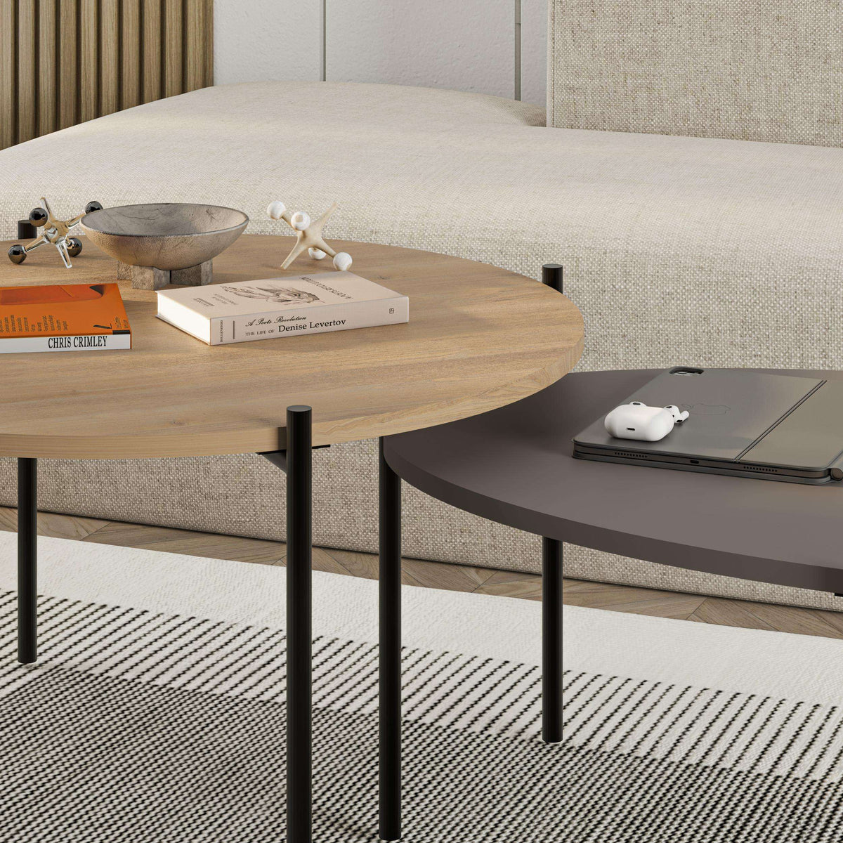 Close-up of round and oval coffee table set with light wood round top and dark oval top