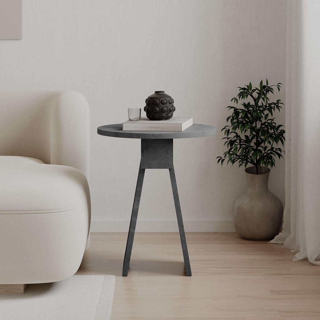 Dark grey round side table with tapered legs and stone-look round tabletop