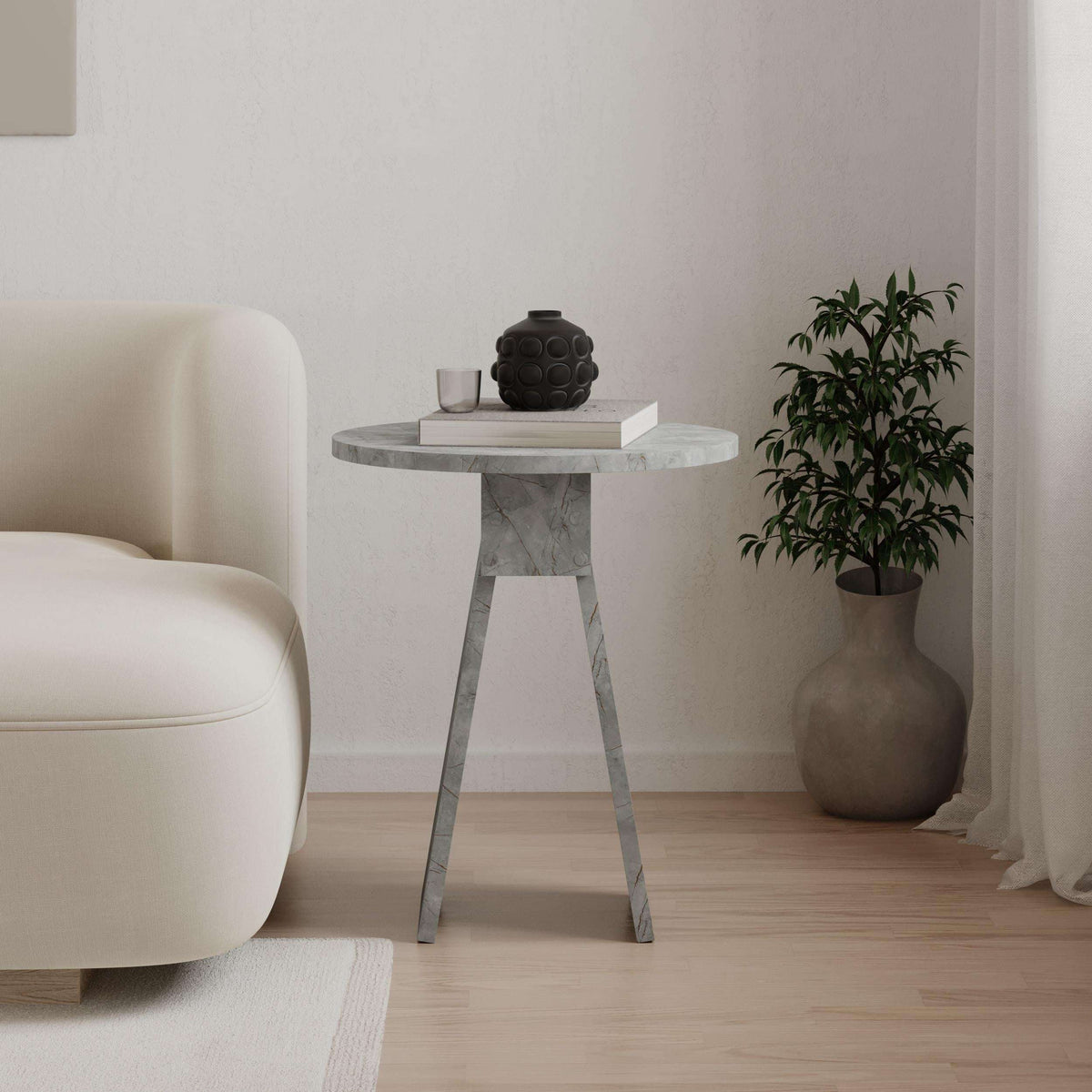 Light grey round side table with stone-look top and angled legs