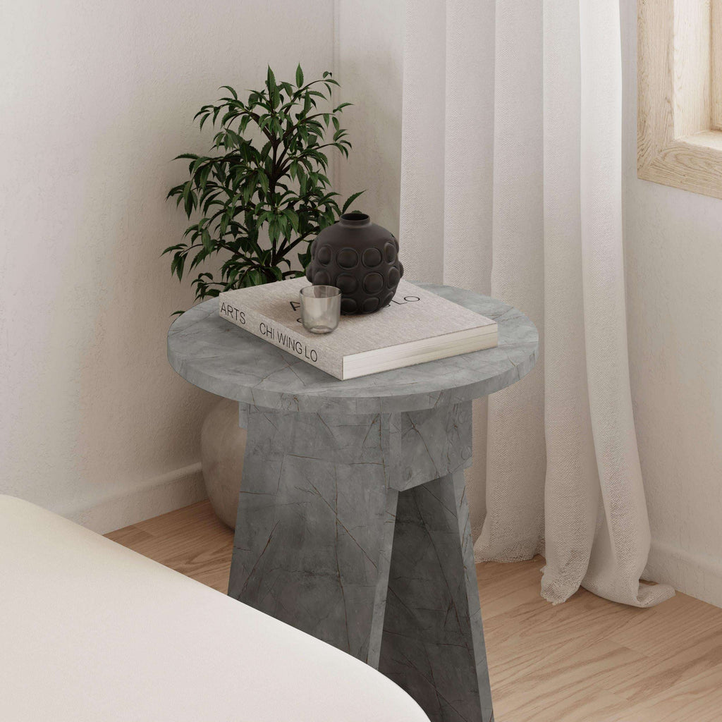 Light grey round side table with stone-look top and tapered leg pedestal base