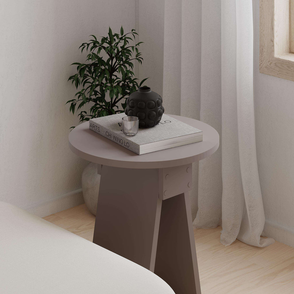 White modern round side table with tapered legs and circular tabletop