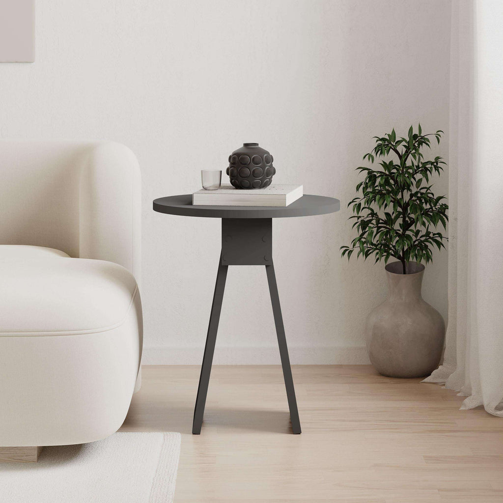 Anthracite round side table with tapered legs, styled with decor on top