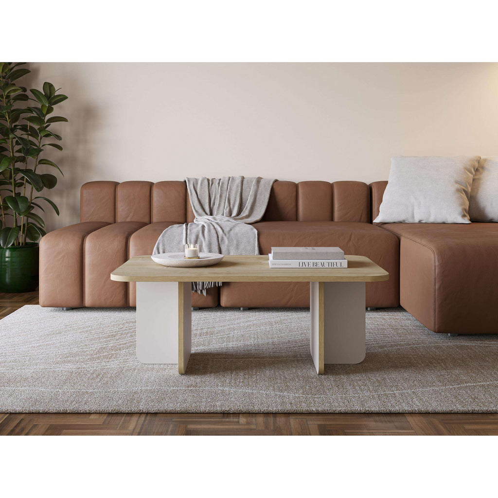 Rectangular coffee table with light top and white cross-cut legs
