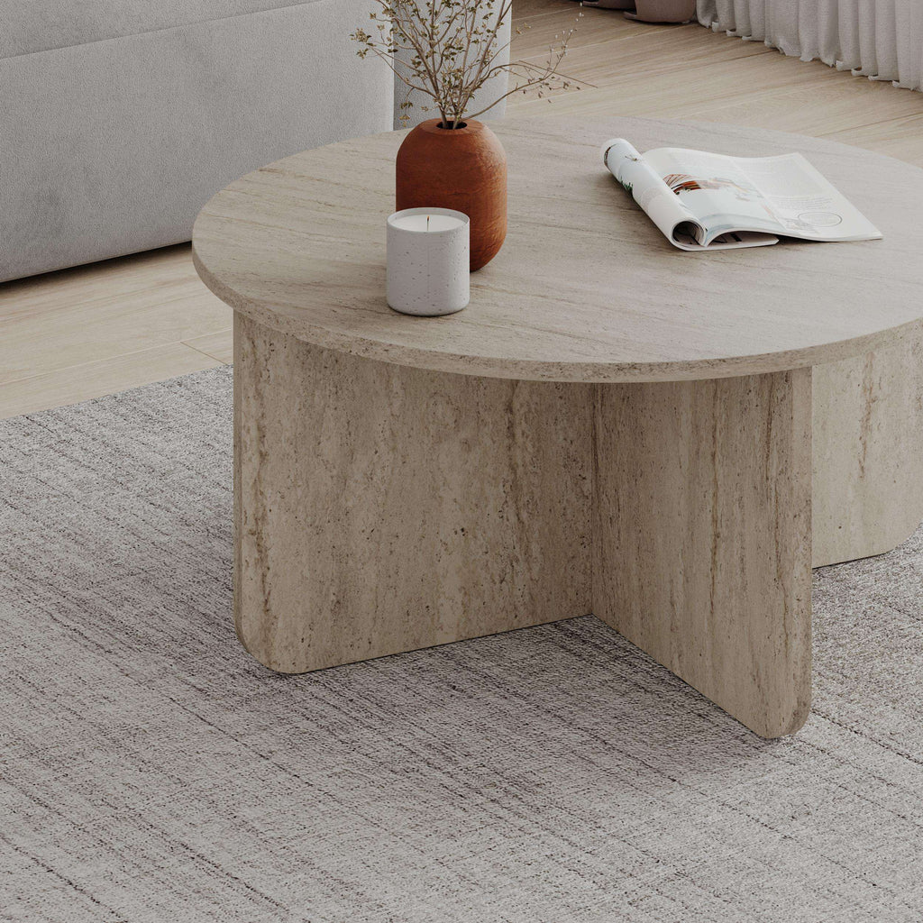 Round coffee table with travertine-look top and curved pedestal base