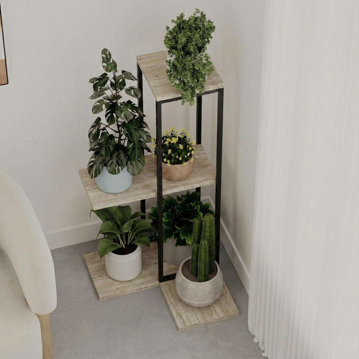 Three-tier black metal plant stand with light stone shelves and open rectangular frame.