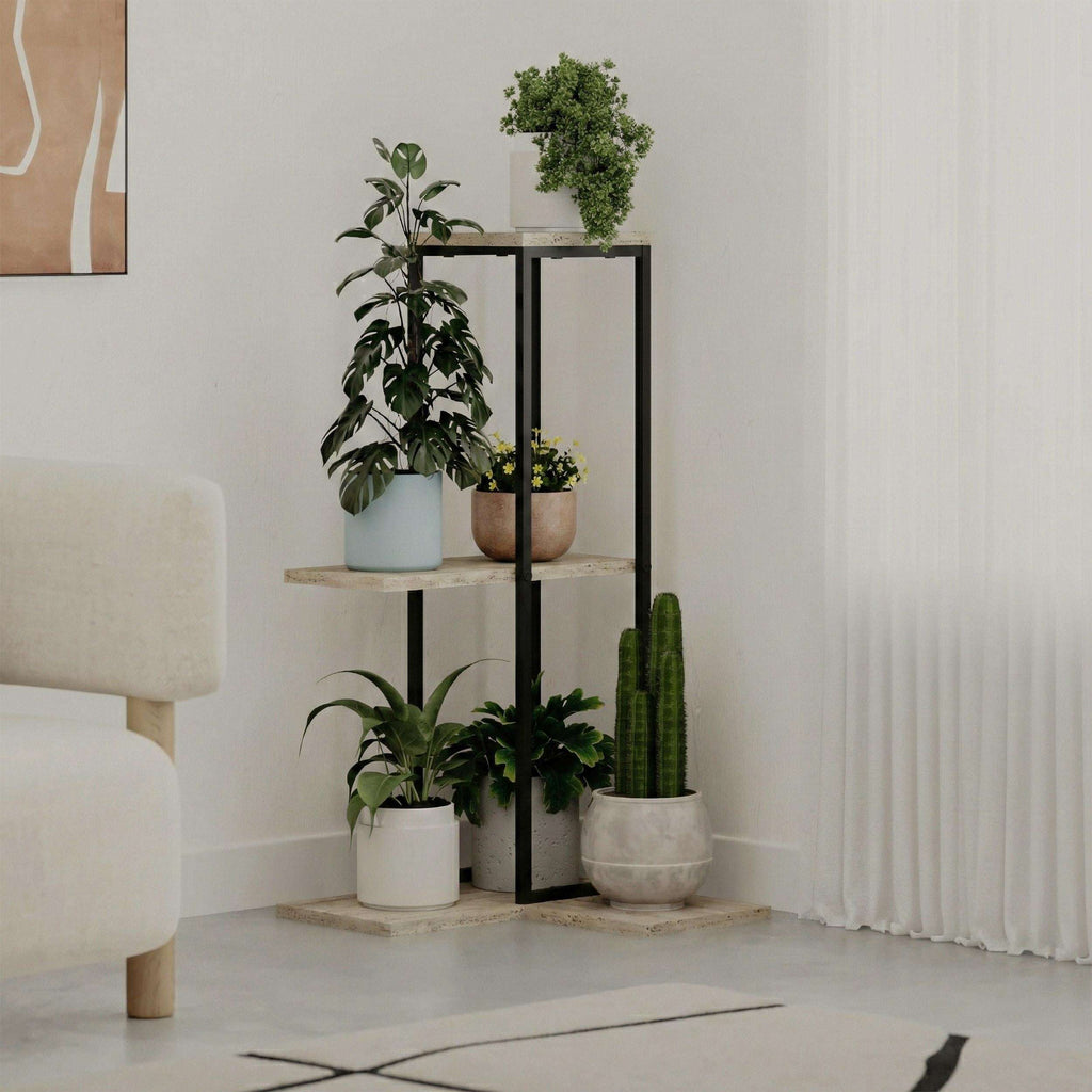 Black metal plant stand with three tiers of light stone shelves for indoor plants.