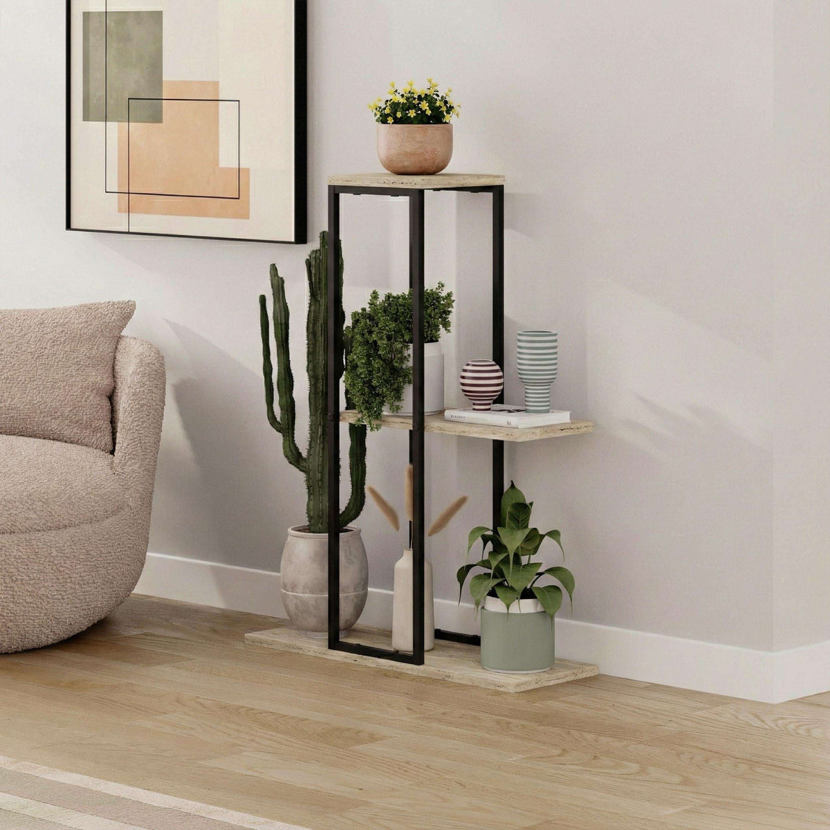 Black metal plant stand with three light stone shelves, open frame design.