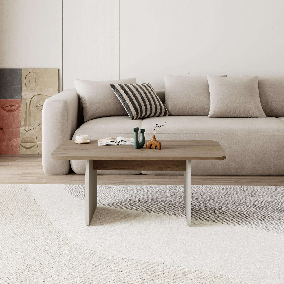 Light oak radius coffee table with rounded top and four curved legs