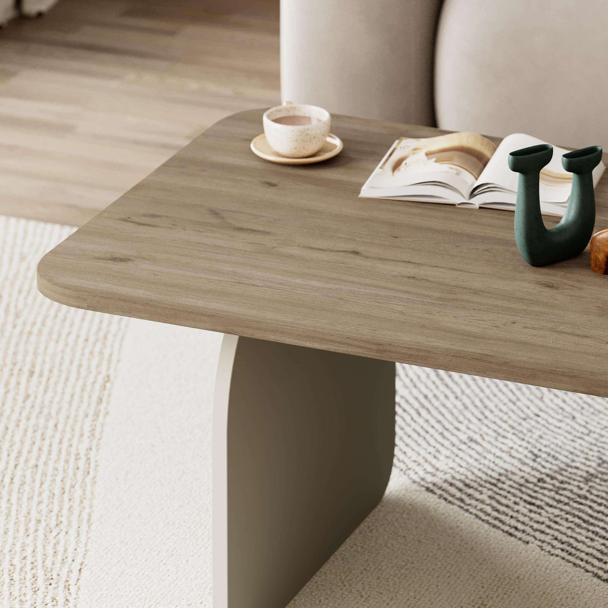 Radius coffee table with light oak finish, rounded rectangular top and curved legs