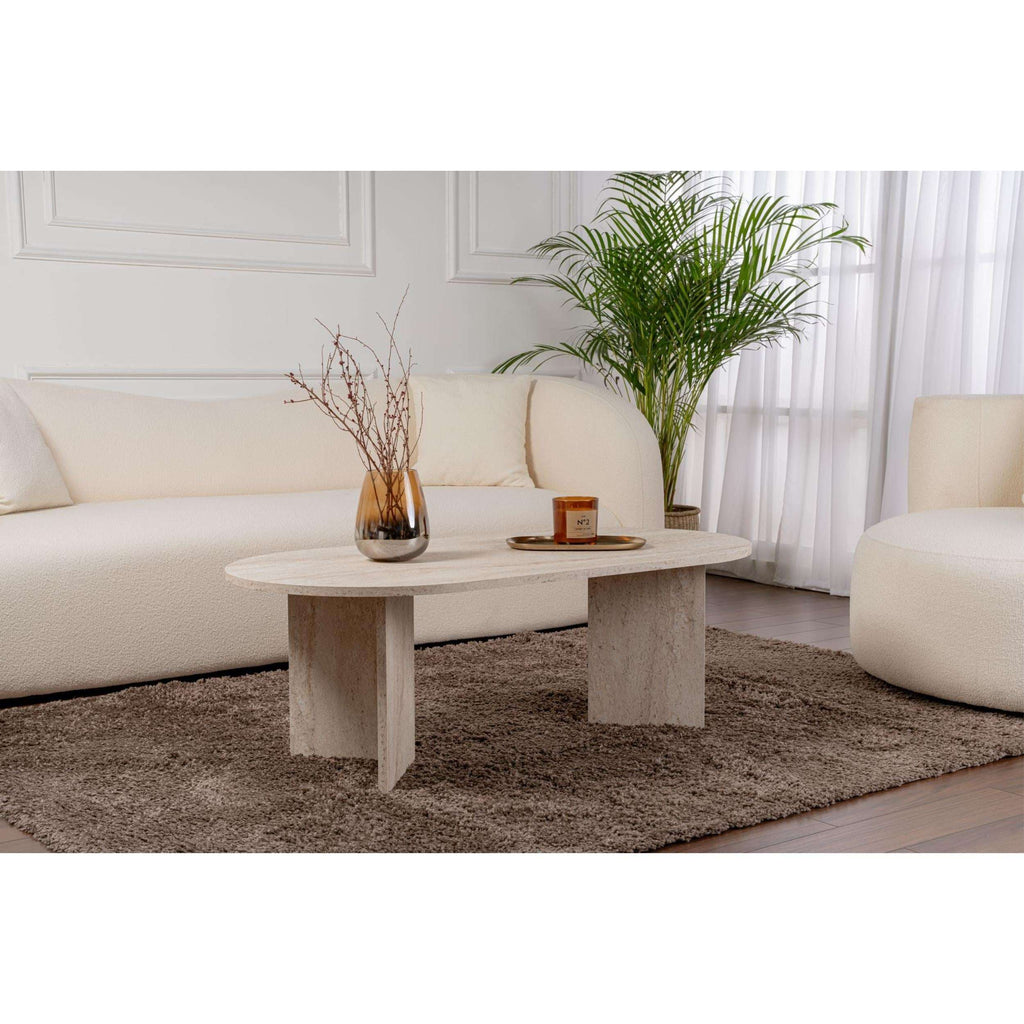 Oval travertine coffee table with stone-textured top and pedestal-style legs