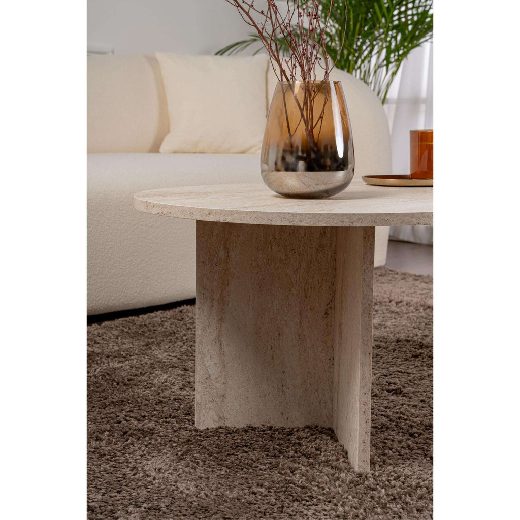 Travertine oval coffee table leg close-up with stone-textured tabletop edge