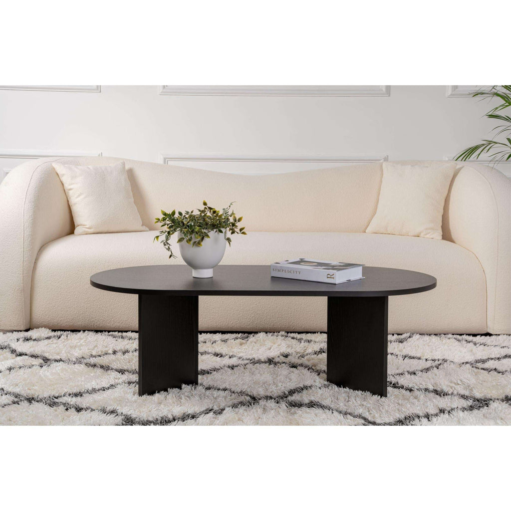 Black oval coffee table with centered legs and dark, rounded tabletop