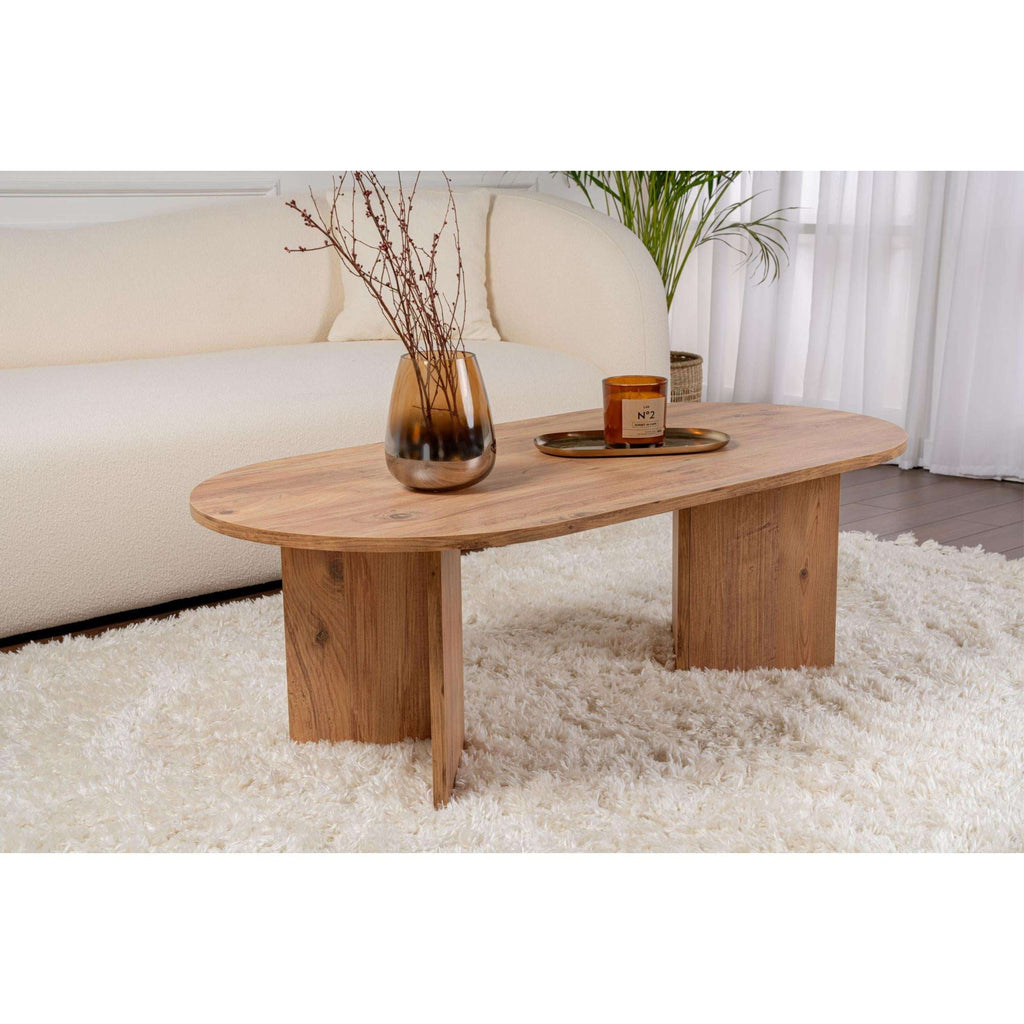 Natural wood oval coffee table with tapered legs and rounded corners.