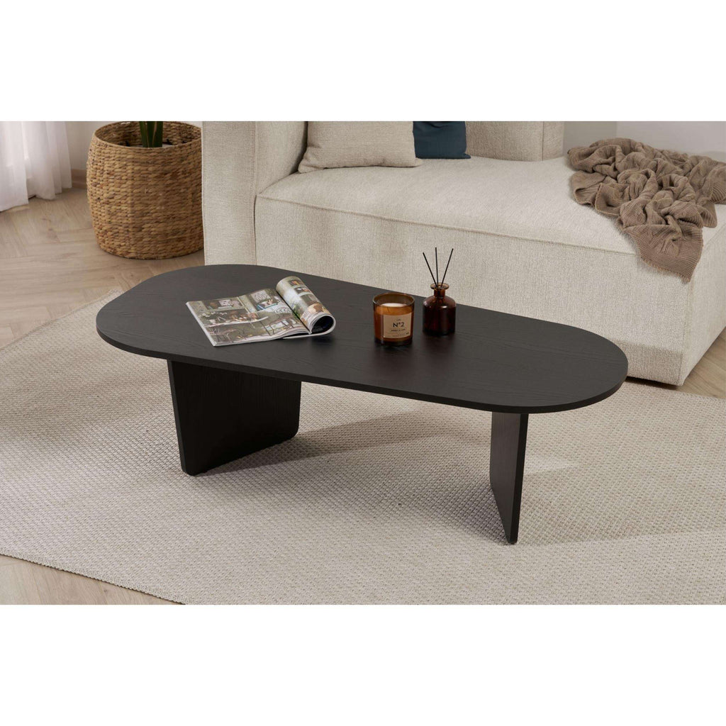 Dark oval coffee table with tapered legs and rounded tabletop