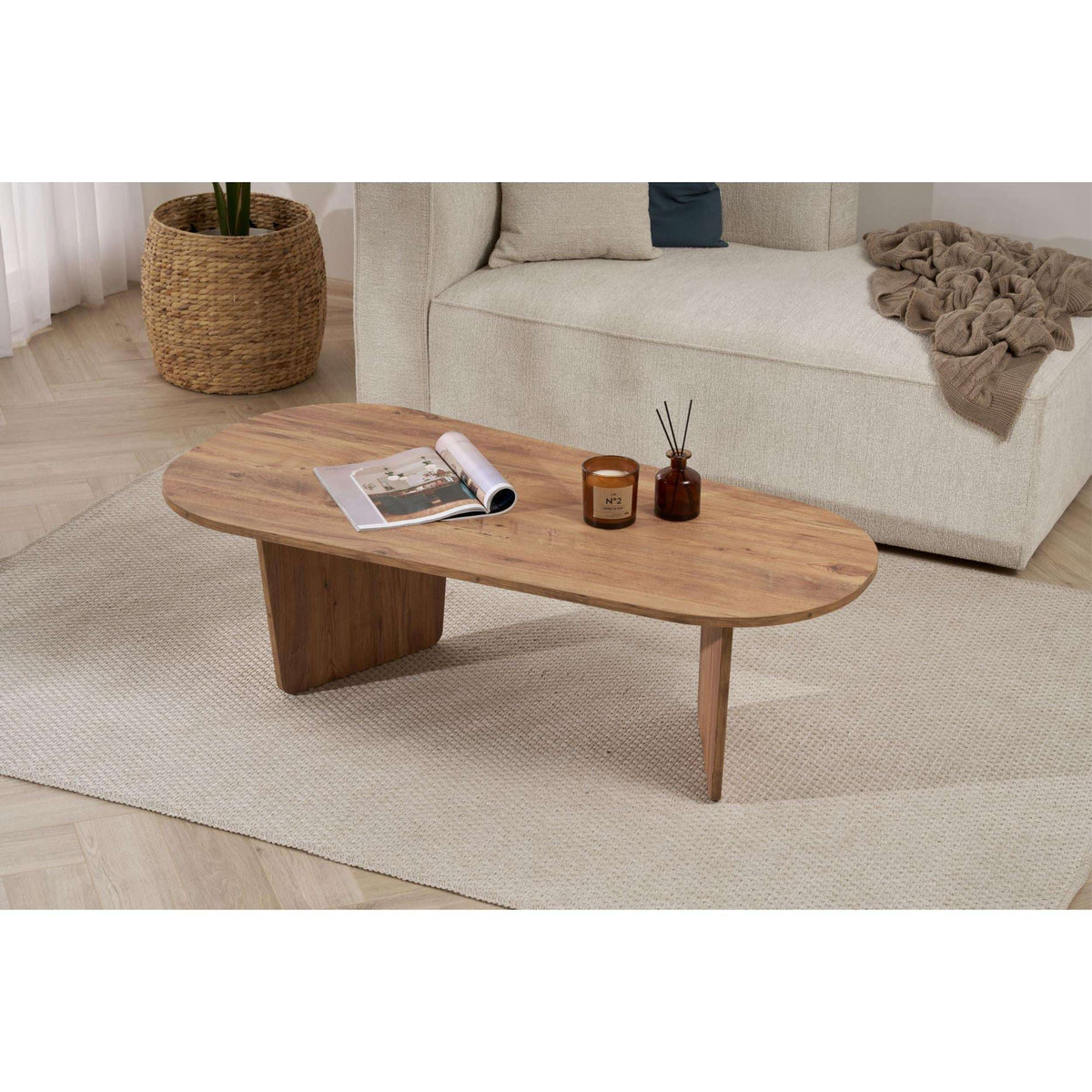 Natural wood oval coffee table with modern low profile and angled leg supports