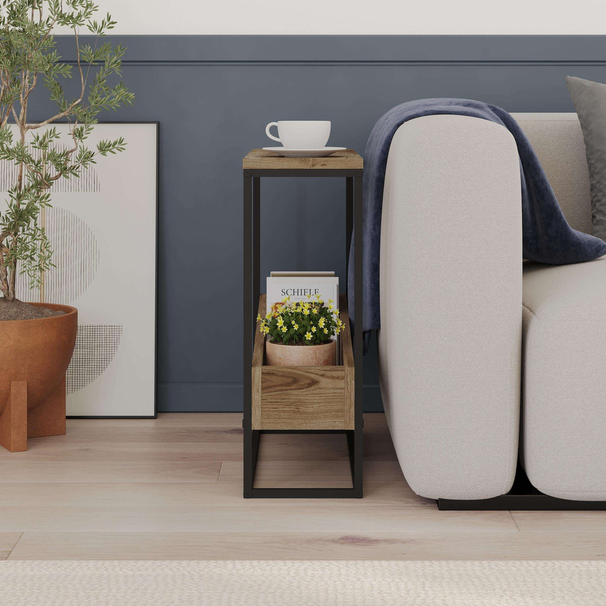 Slim side table with oak shelves and black metal frame, shown beside a sofa