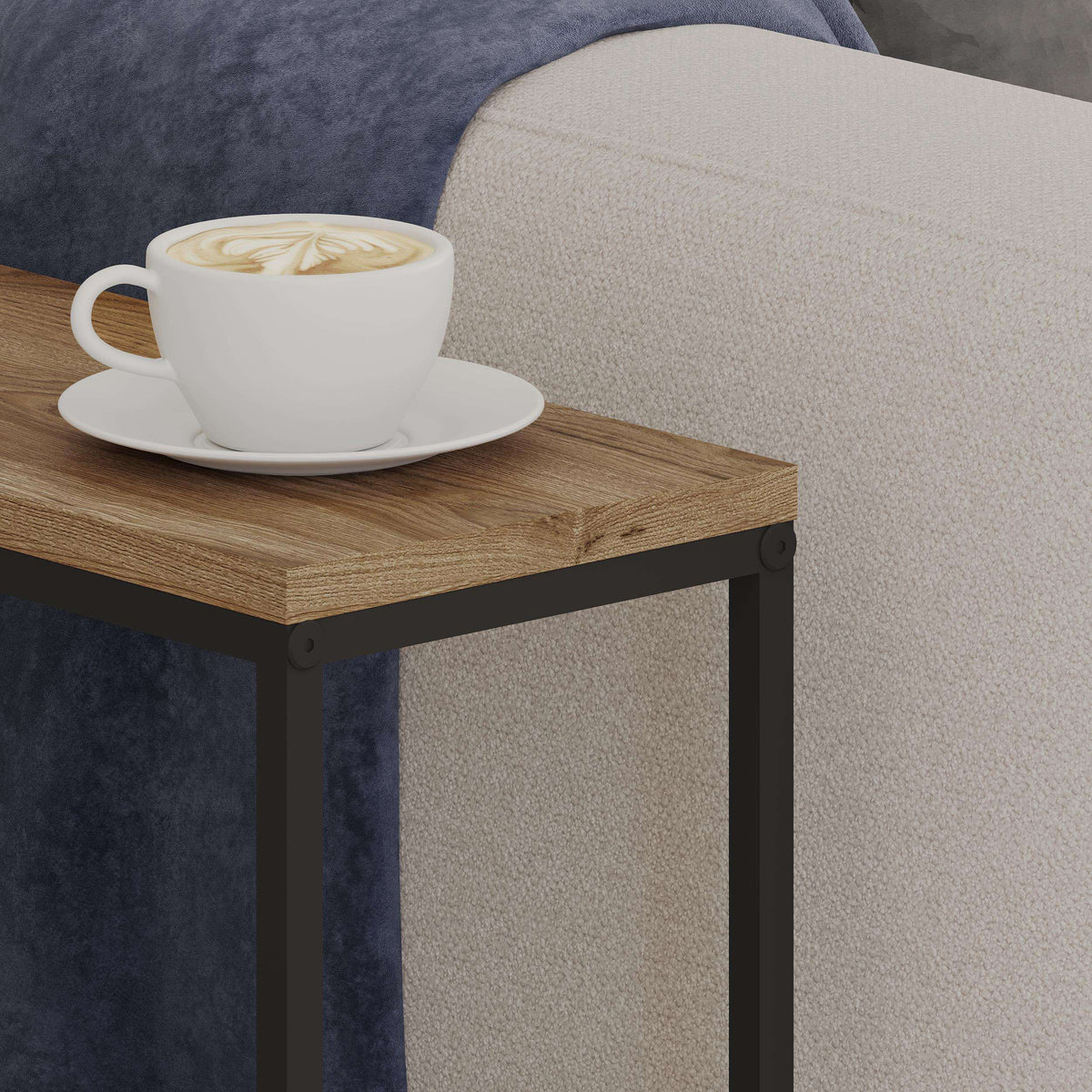 Close-up of wood top and black metal legs on a slim side table.