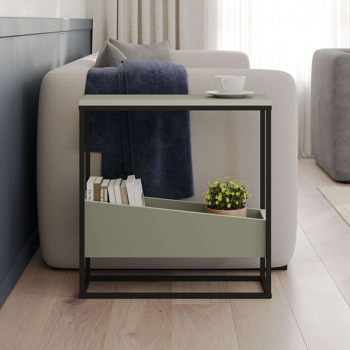 Slim side table with open shelf, dark frame and light top beside upholstered seating