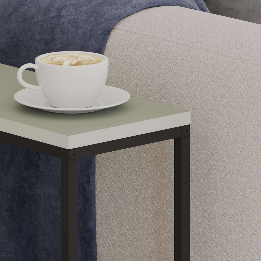 Ash green side table top with white cup, black frame corner detail