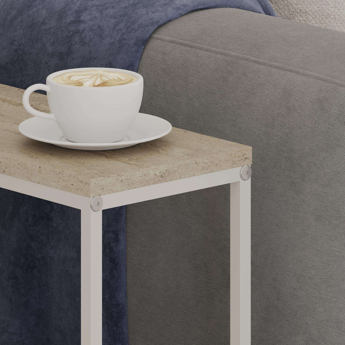 Travertine-style side table top with white cup on a black-trimmed frame