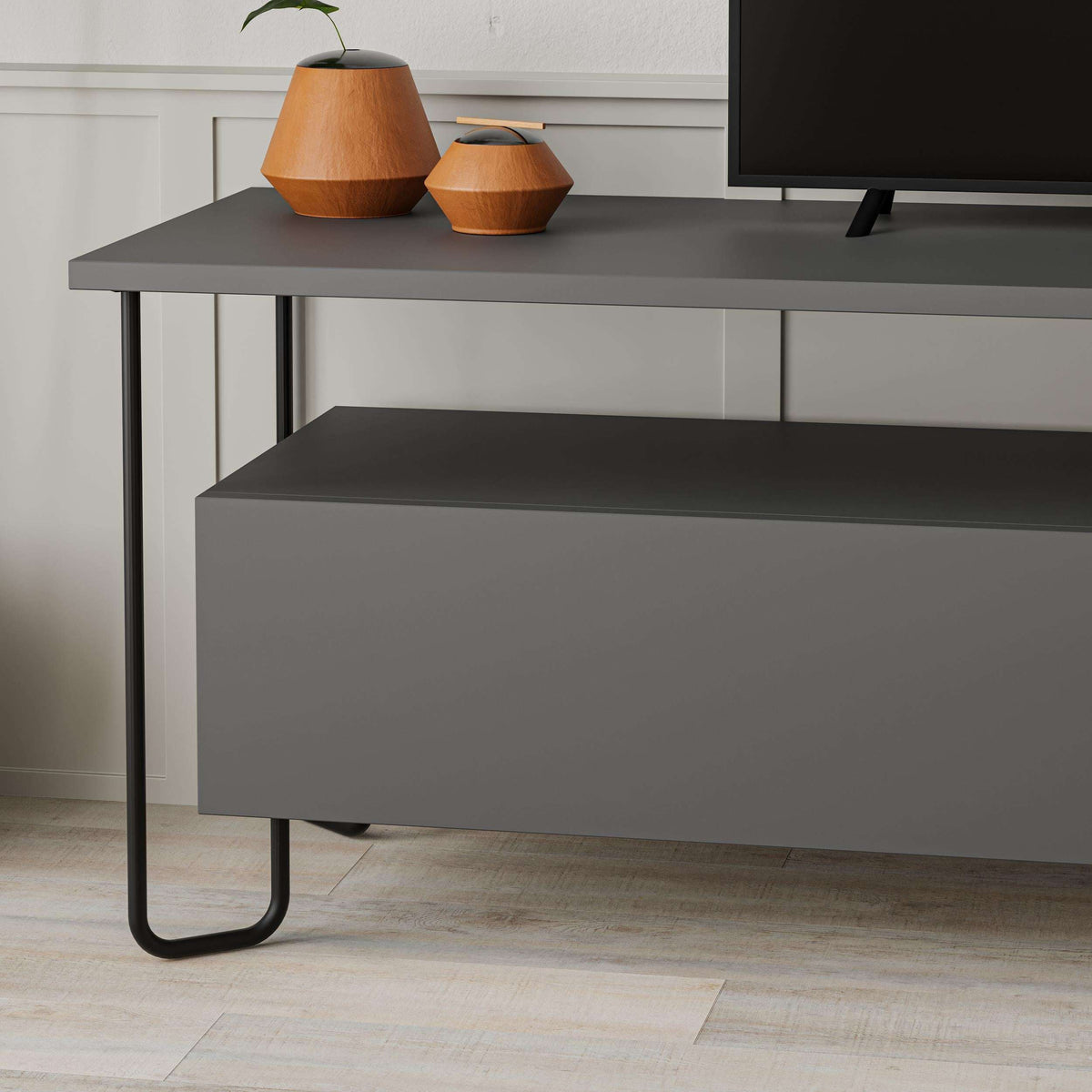 Modern TV unit with storage cabinet, dark grey countertop and cabinet doors, metal legs