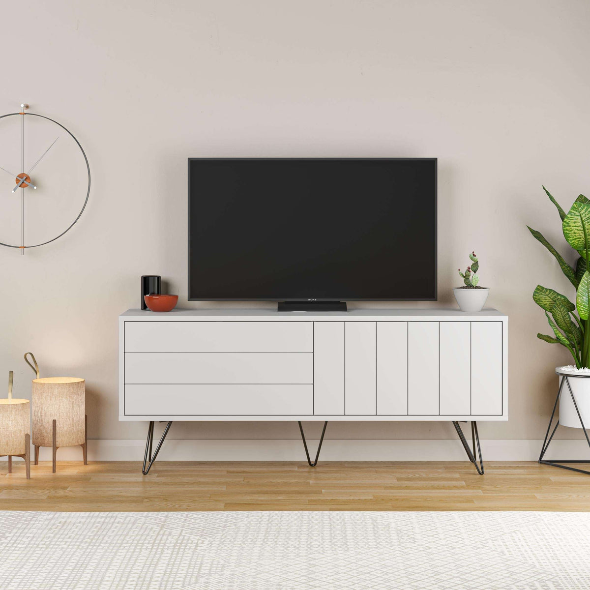 White TV stand with drawer and slatted cabinet doors, slender black legs