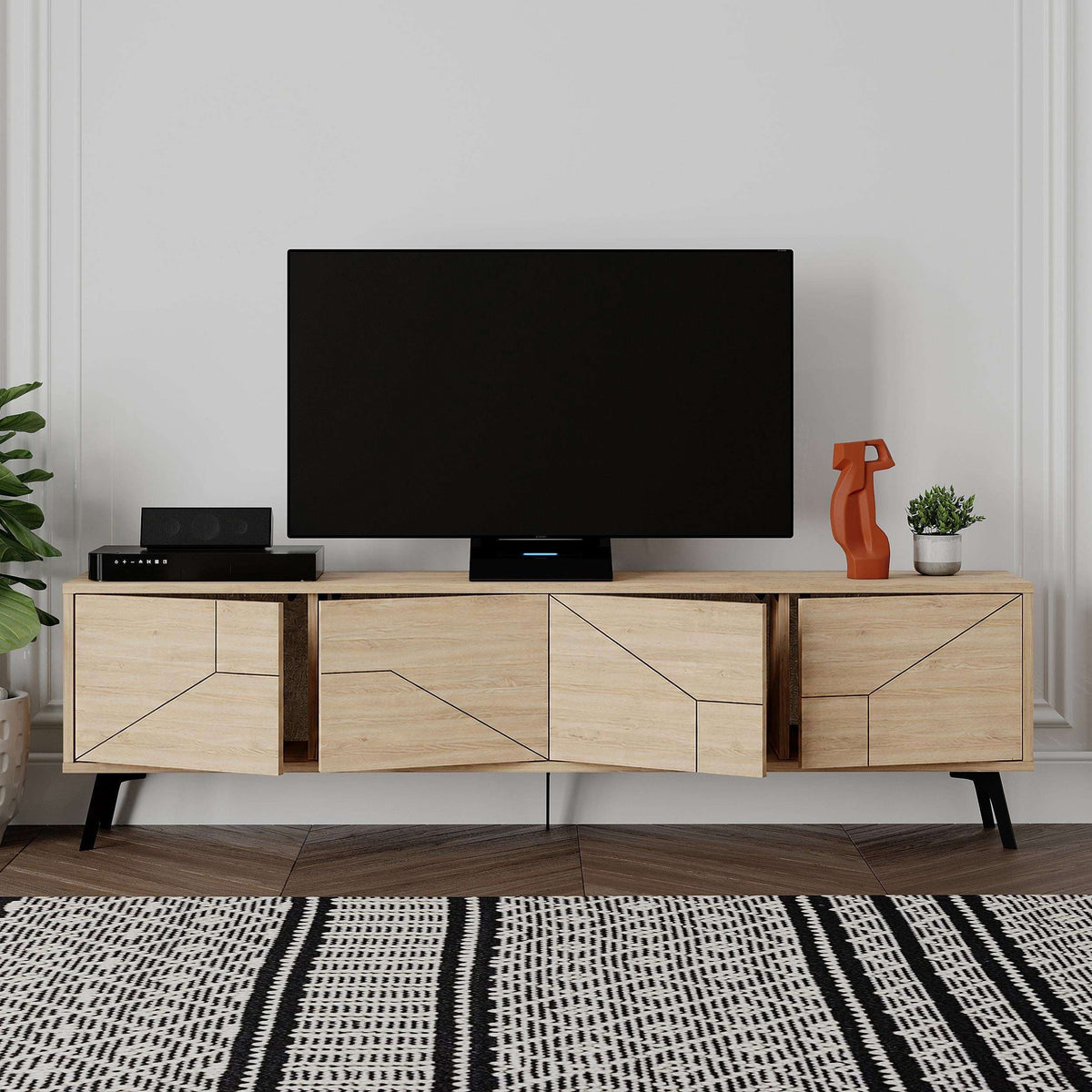 Oak media console with open center shelf, geometric cabinet doors, and black feet